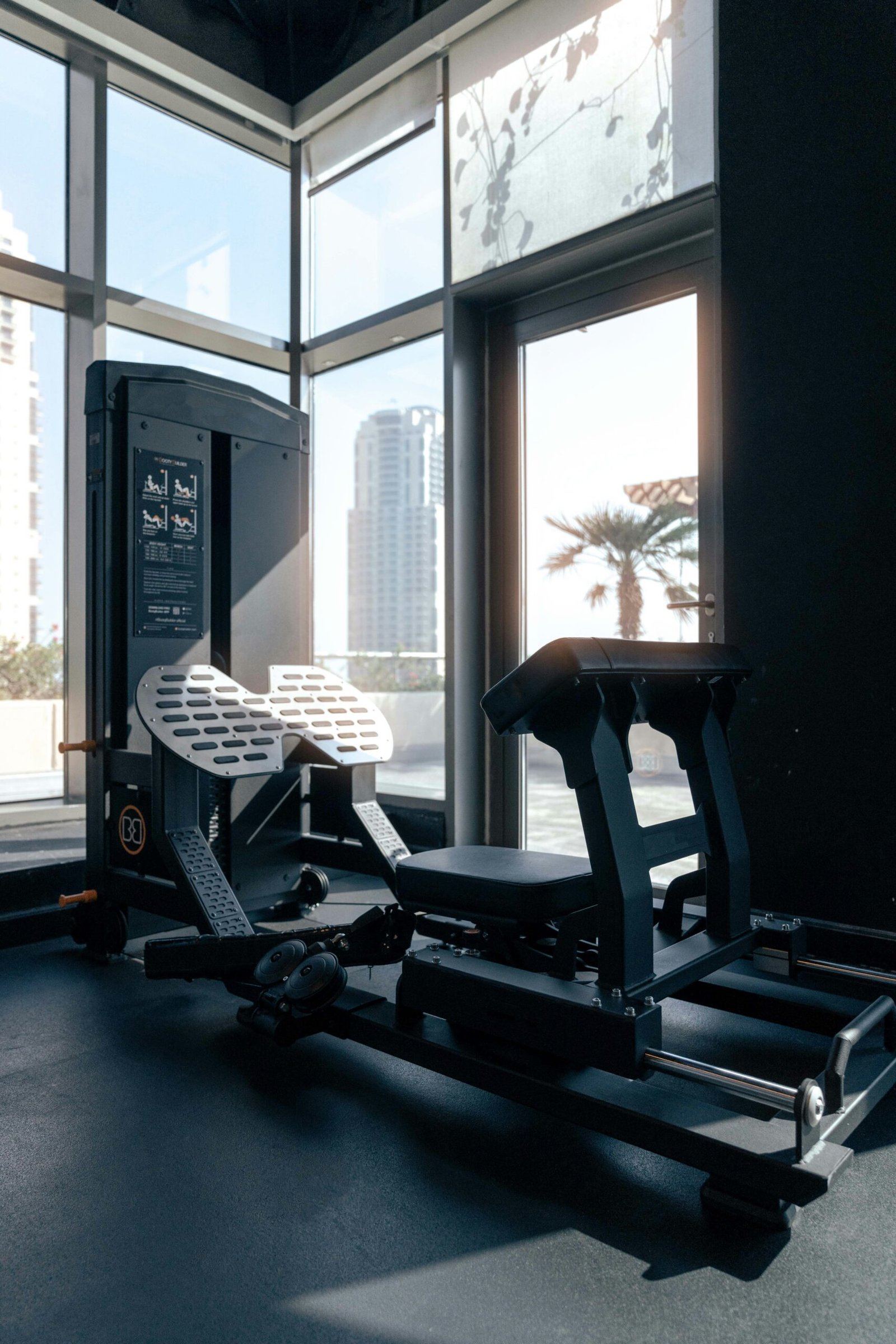 A gym room with a treadmill and a window